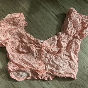 pink crop top with buttons and puff sleeves